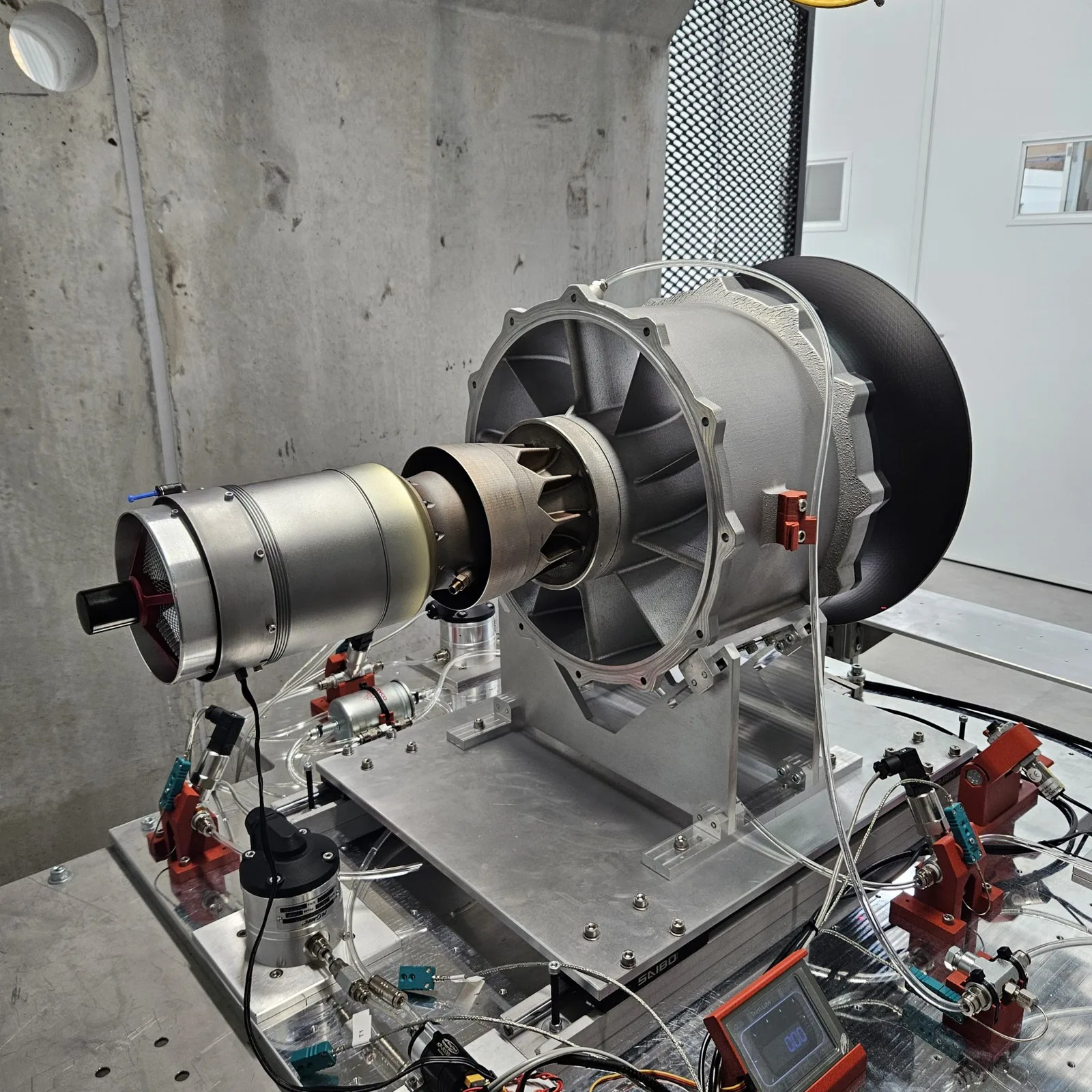 An Aurora Labs engine mounted on an instrumented test stand with sensors and wiring
