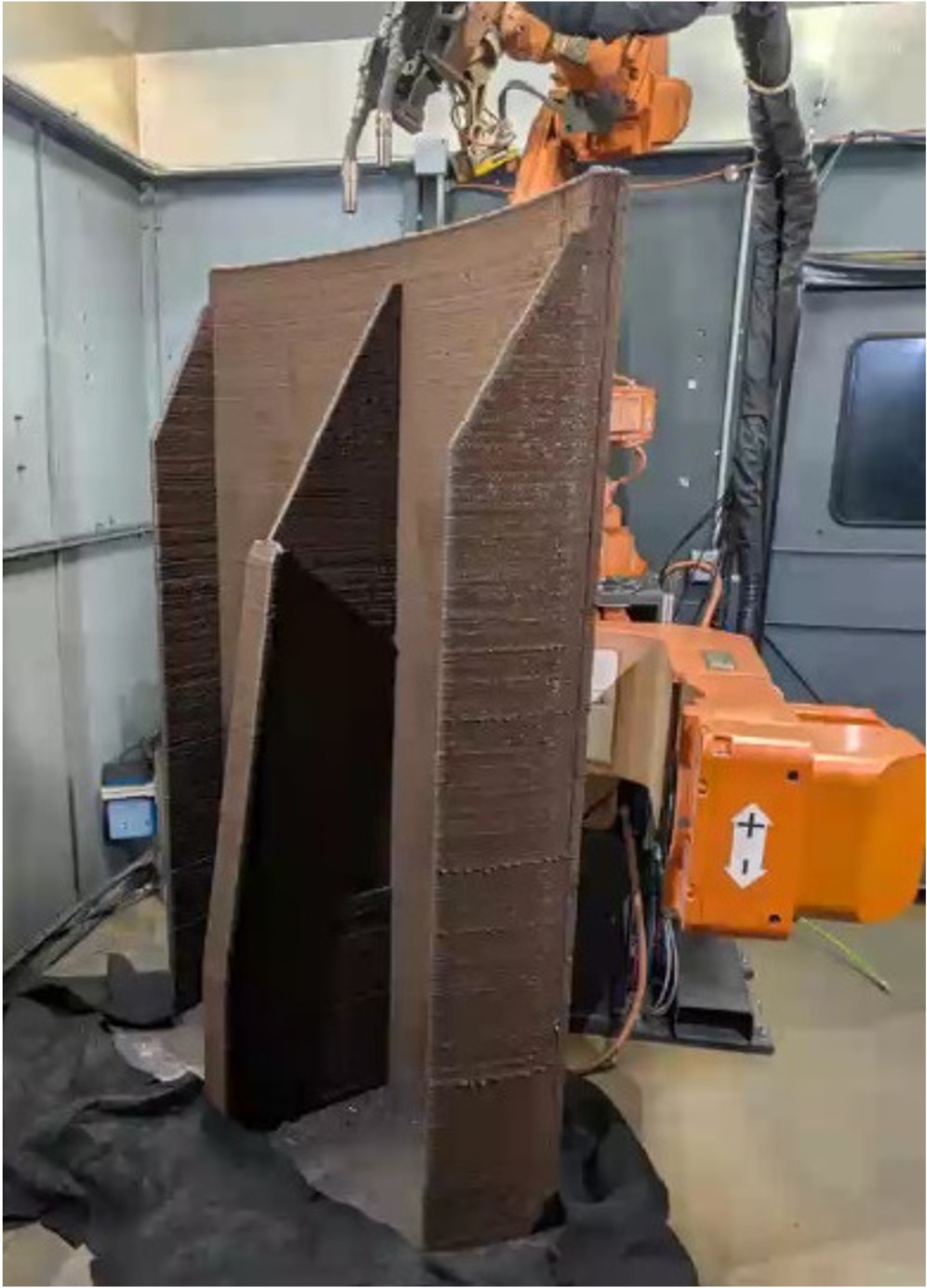 Robotic welding system building a large curved steel mold with support ribs