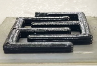 Black interlocking electrodes printed on a small pale cement slab