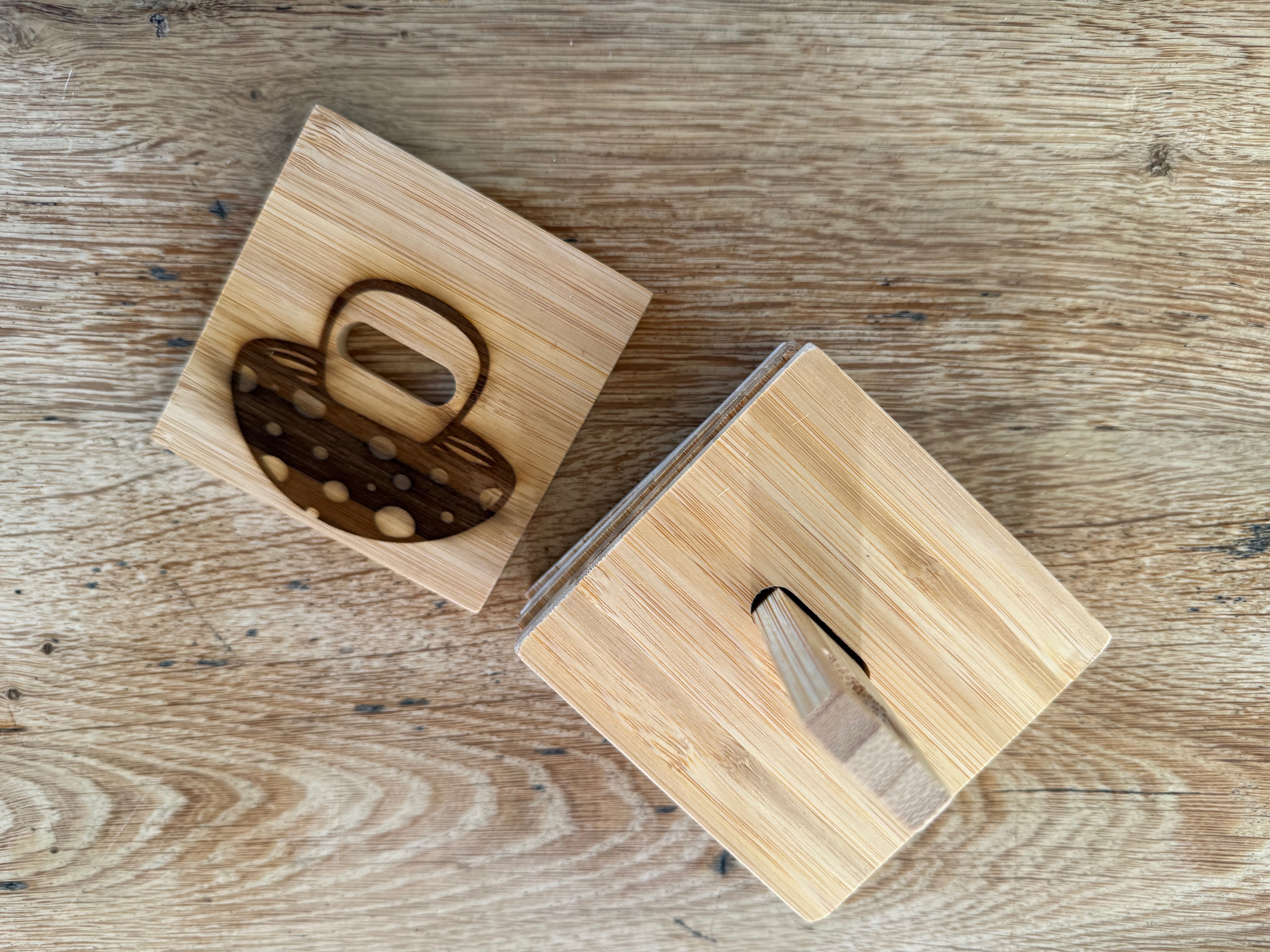 A stack of bamboo bottle opener coasters with the mushroom design engraved on the top one