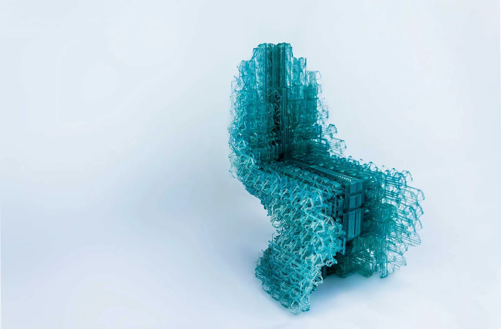 Translucent turquoise printed chair on a white background