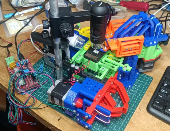The RepRapMicron PIKA machine on a workbench with a USB microscope above the stage