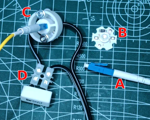 UV LED module, fibre optic cable, adaptor and terminal block with resistor, labelled A to D
