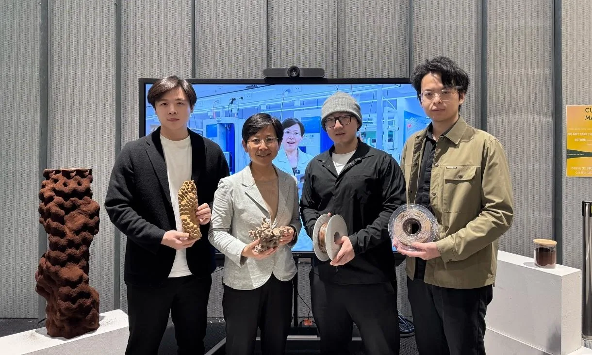 Four members of the research team holding printed samples and filament spools