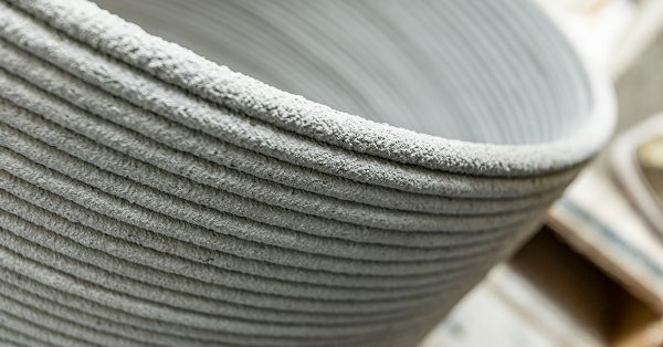 Close view of the ridged, rough surface of a 3D-printed concrete form